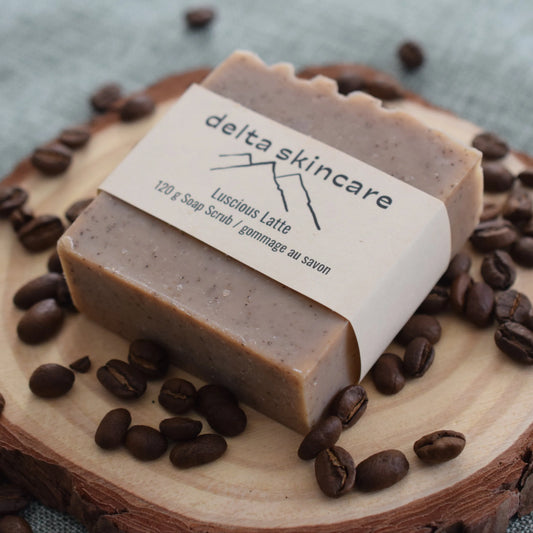 Delta Skincare Luscious Latte soap scrub on wood with coffee beans, natural handmade soap