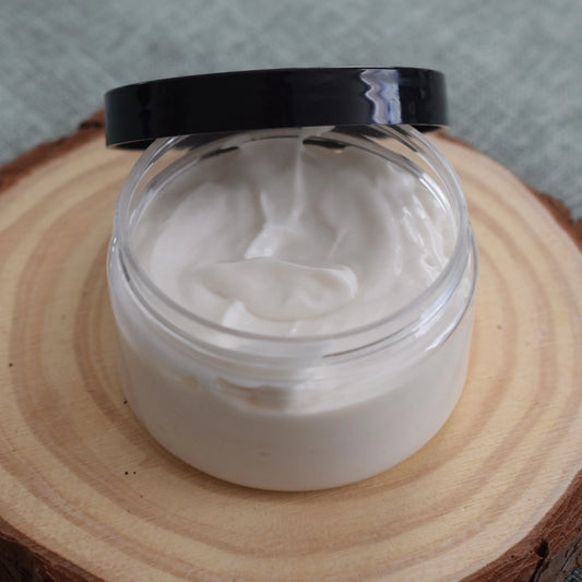 Open jar of natural face cream on a wooden slab, skincare product photography