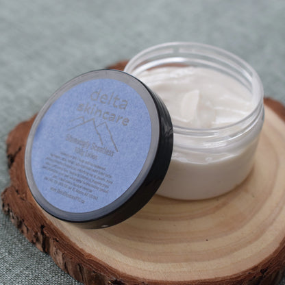 Delta Skincare Stoningly Seamless lotion jar on wooden coaster, skincare product photography