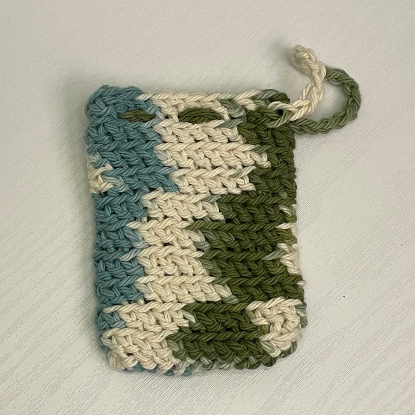green, white, and blue crochet soap saver