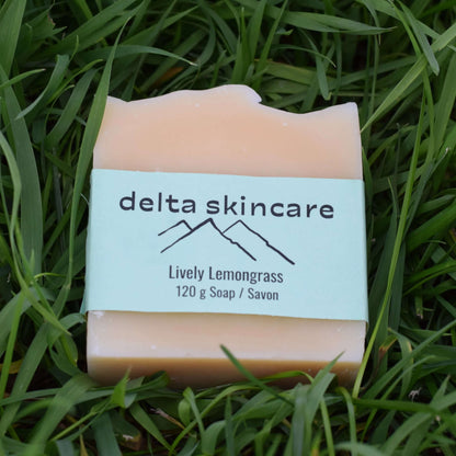 Delta Skincare Lively Lemongrass soap bar on green grass, natural handmade soap.